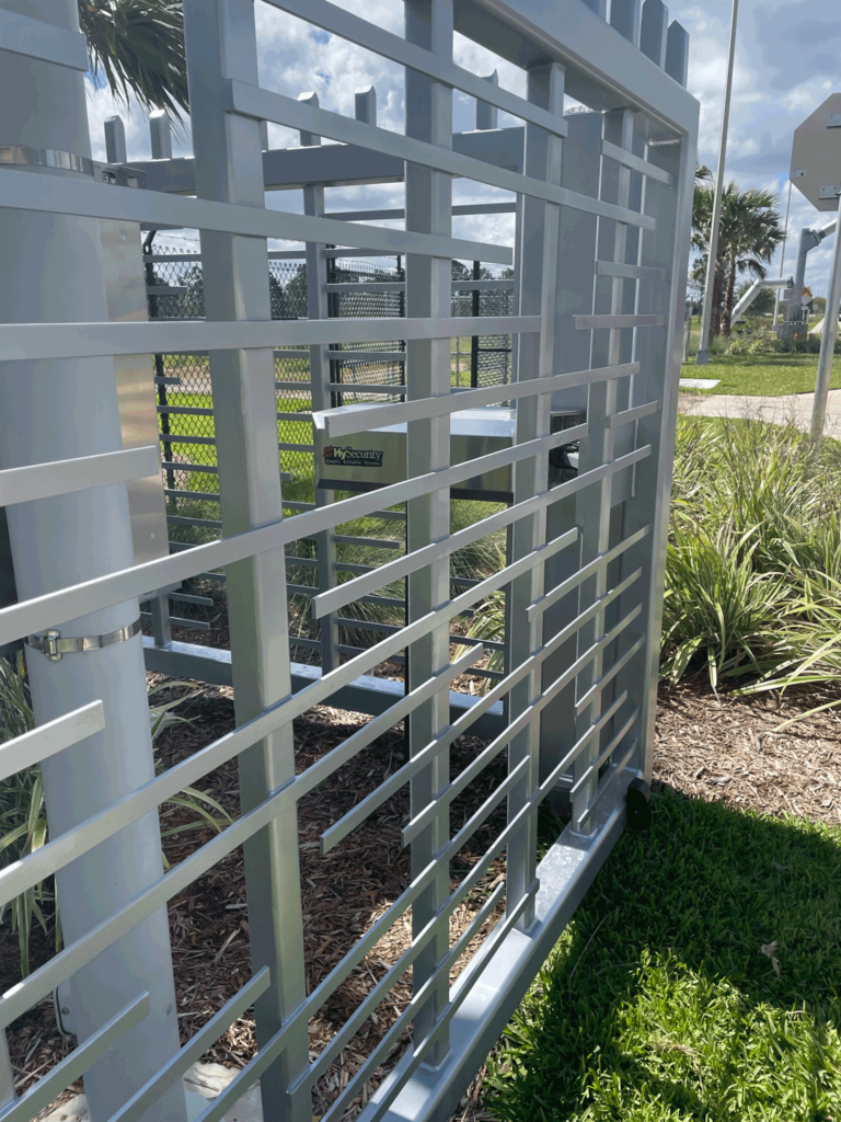 Close-up of the ornamental gate with the HydraSwing operator visible through its design, illustrating the integration of technology and security.